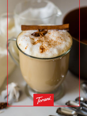Torani Amaretto Syrup close-up pouring over crema.