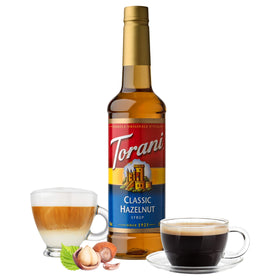 Torani Classic Hazelnut Syrup being poured for a creamy latte.