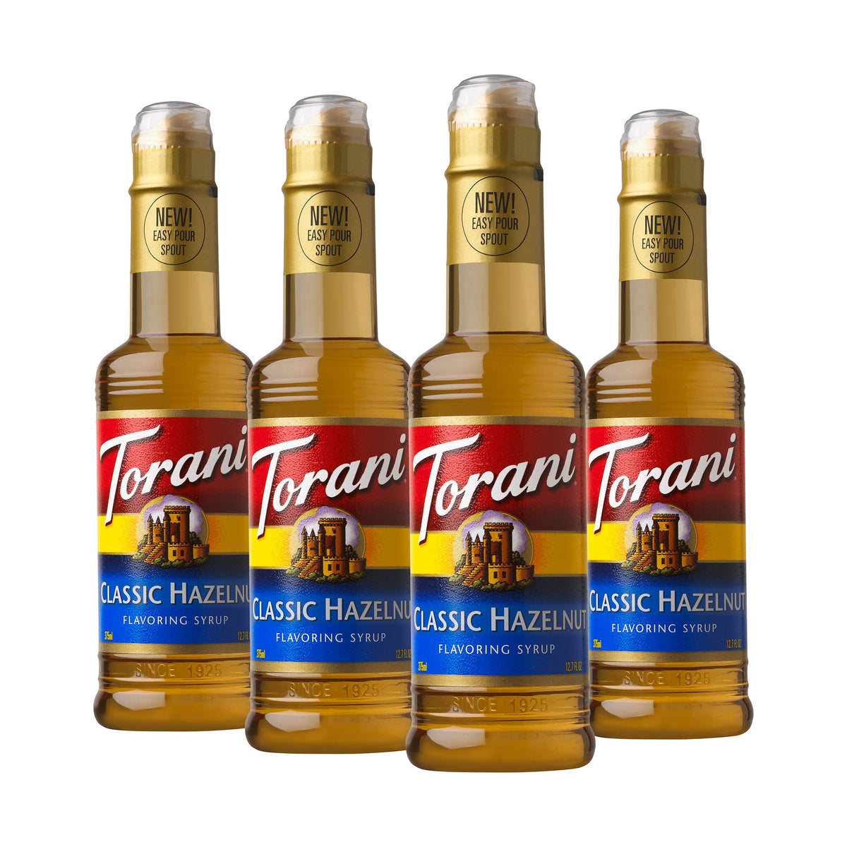 Torani Hazelnut syrup bottle pouring into hot coffee for a rich, nutty flavor