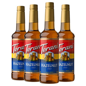 Torani Hazelnut Syrup bottle pouring rich hazelnut flavor into beverages