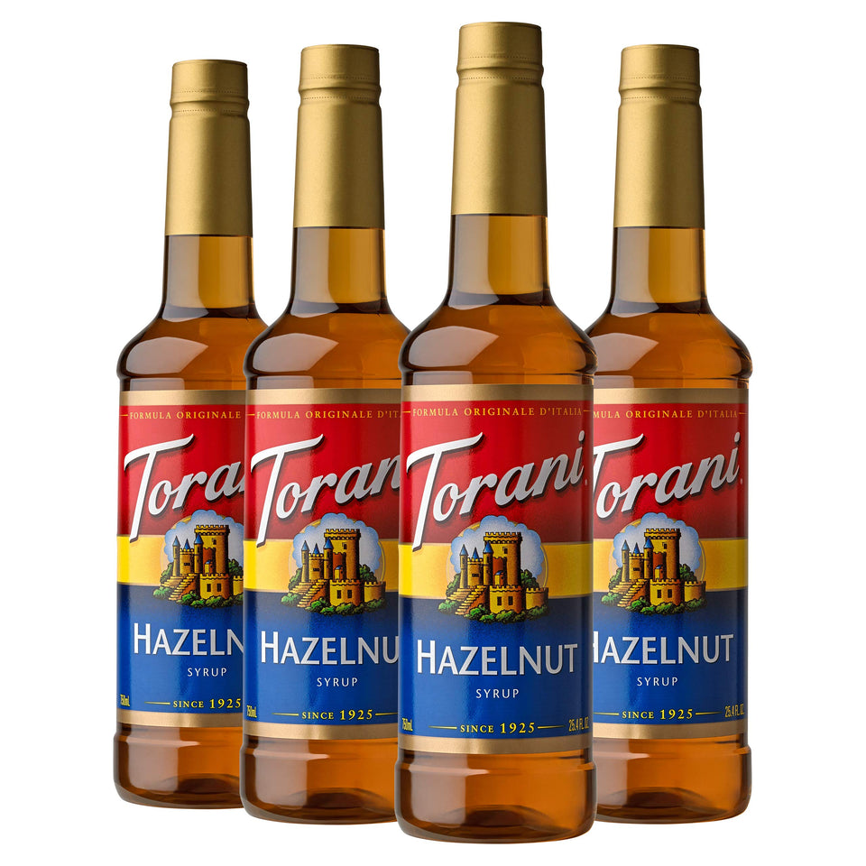 Torani Hazelnut Syrup bottle pouring rich hazelnut flavor into beverages