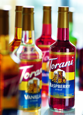 Torani Hazelnut Syrup pour bottle showcasing quick flavor boost for drinks.