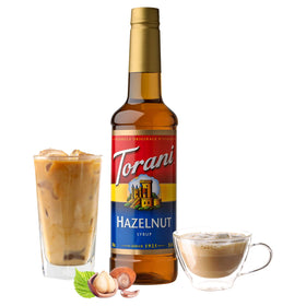 Torani Hazelnut Syrup being poured into a glass for a latte-style drink