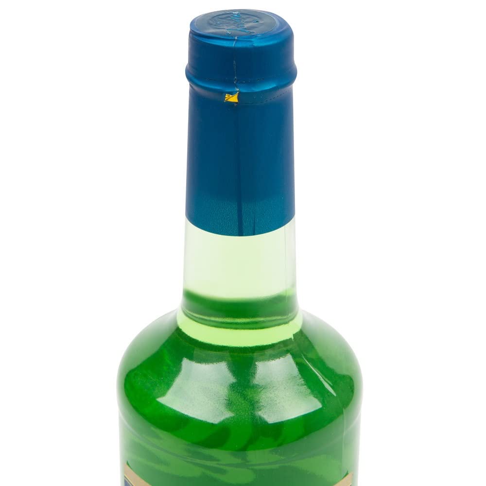 Torani Lime Syrup in glass with lime wedge for sparkling beverages.