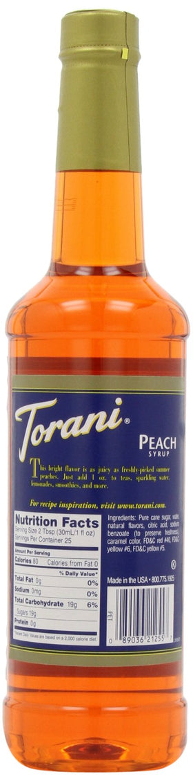 Torani peach syrup bottle with glass of iced tea, showcasing versatility.