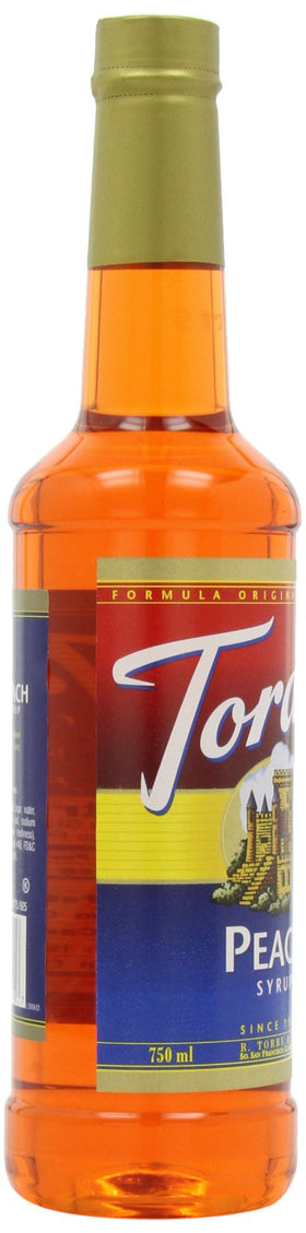 Torani peach syrup bottle on kitchen counter for home flavoring.