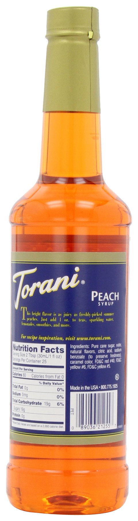 Torani peach bottle pouring, perfect for flavored lattes and sparkling sodas.