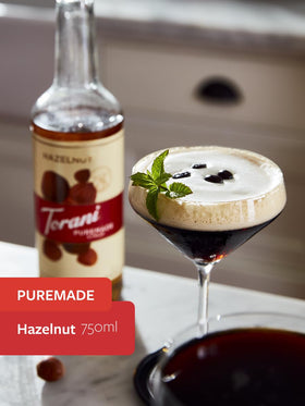 Torani Puremade Hazelnut Syrup being poured into a mug for latte