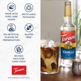 Torani Raspberry Syrup poured into a glass with ice for a refreshing beverage