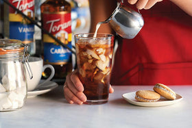 Torani Sugar Free Brown Sugar Cinnamon syrup pump in use for controlled flavoring