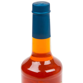 Close-up of Torani sugar-free orange syrup bottle on a café counter