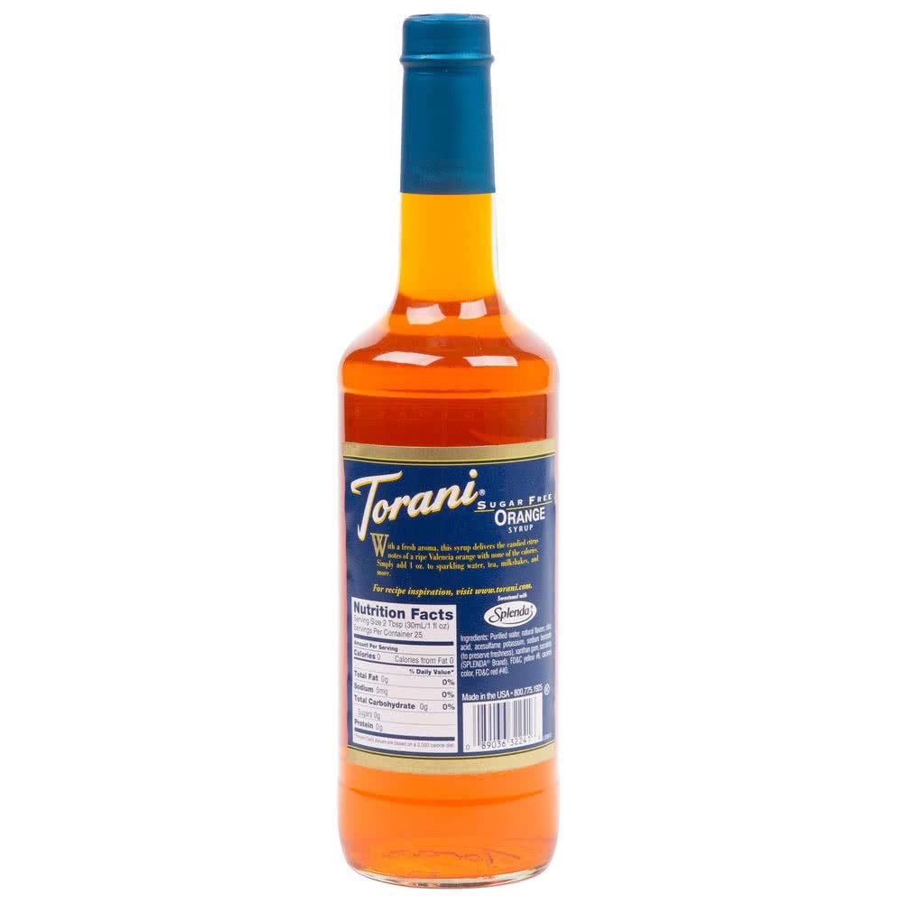 Torani orange syrup being poured into a glass for a citrus drink