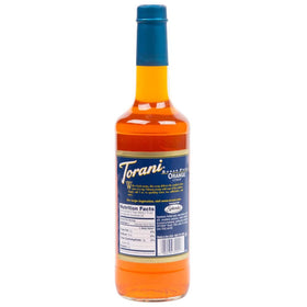 Torani orange syrup being poured into a glass for a citrus drink