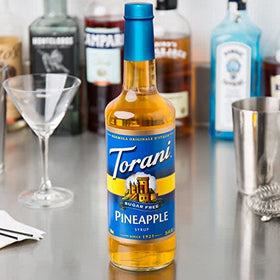 Torani Sugar-Free Pineapple Syrup being poured for a pineapple-forward, low-sugar drink