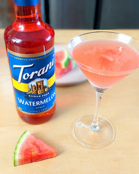 Torani Sugar Free Watermelon Syrup pours into a glass for refreshing drinks.