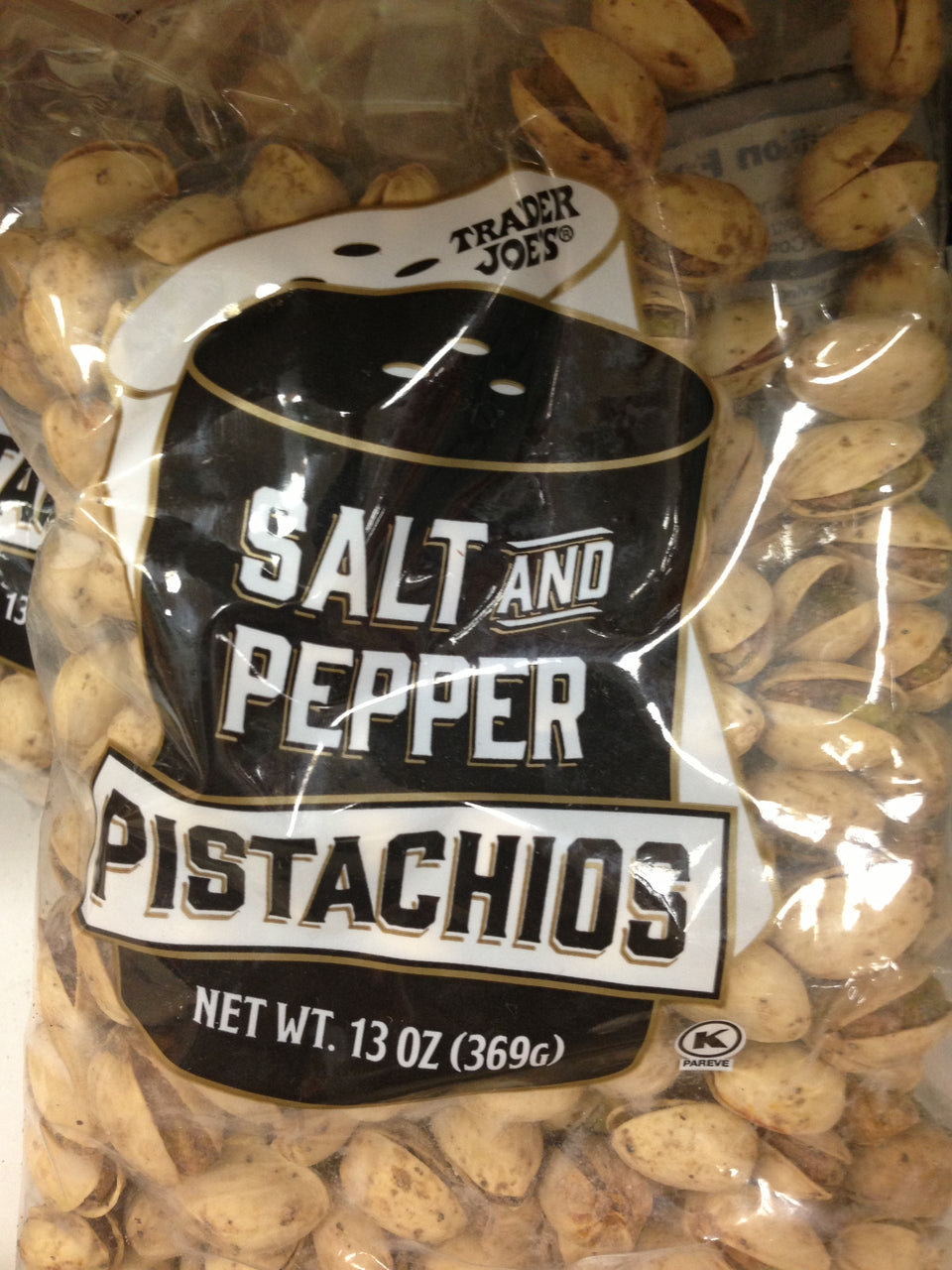 Trader Joe's Salt and Pepper Pistachios bag; crunchy, savory snack for on-the-go.
