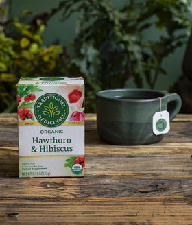Traditional Medicinals hawthorn hibiscus tea sachets arranged for daily wellness moment.