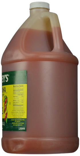 Pouring Trappey's Louisiana Original Hot Sauce to add bold heat