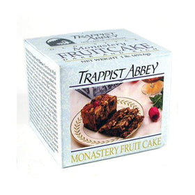 Sliced Trappist Abbey fruitcake on a serving board, perfect for sharing.