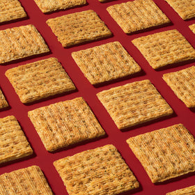 Triscuit crackers with cheese on a board, highlighting pairing ideas