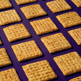 Triscuit Garden Herb crackers on a cheese board, perfect with toppings.