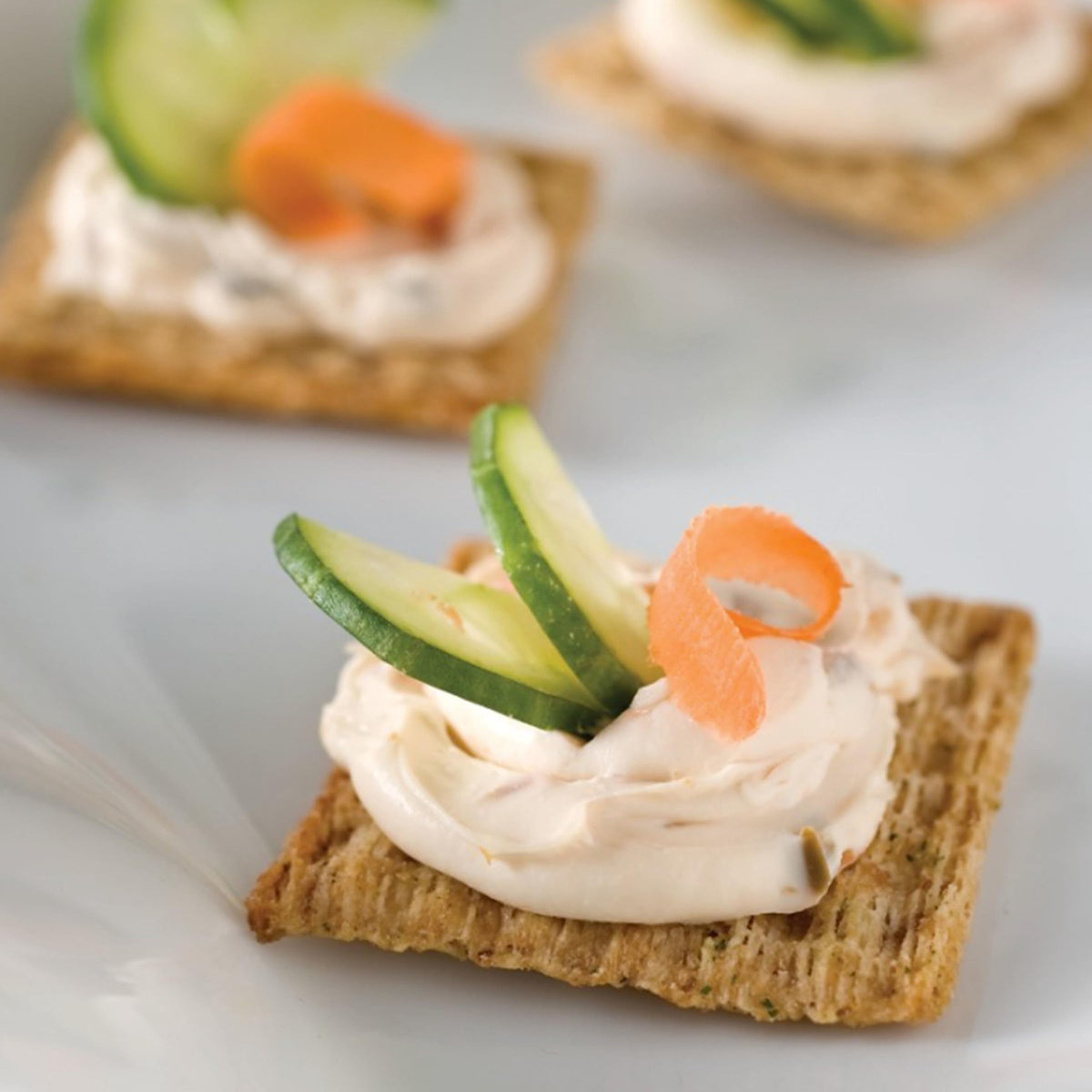 Triscuit Garden Herb whole grain base, ideal for toppings and dips.