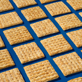 Triscuit Original crackers with dips and spreads on a board.