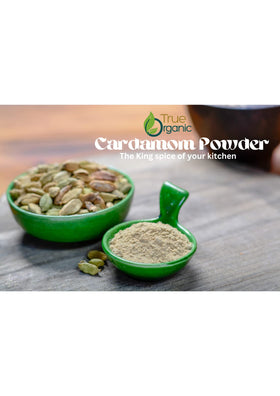 True Organic Cardamom Powder measuring spoon, ideal for precise spice additions.