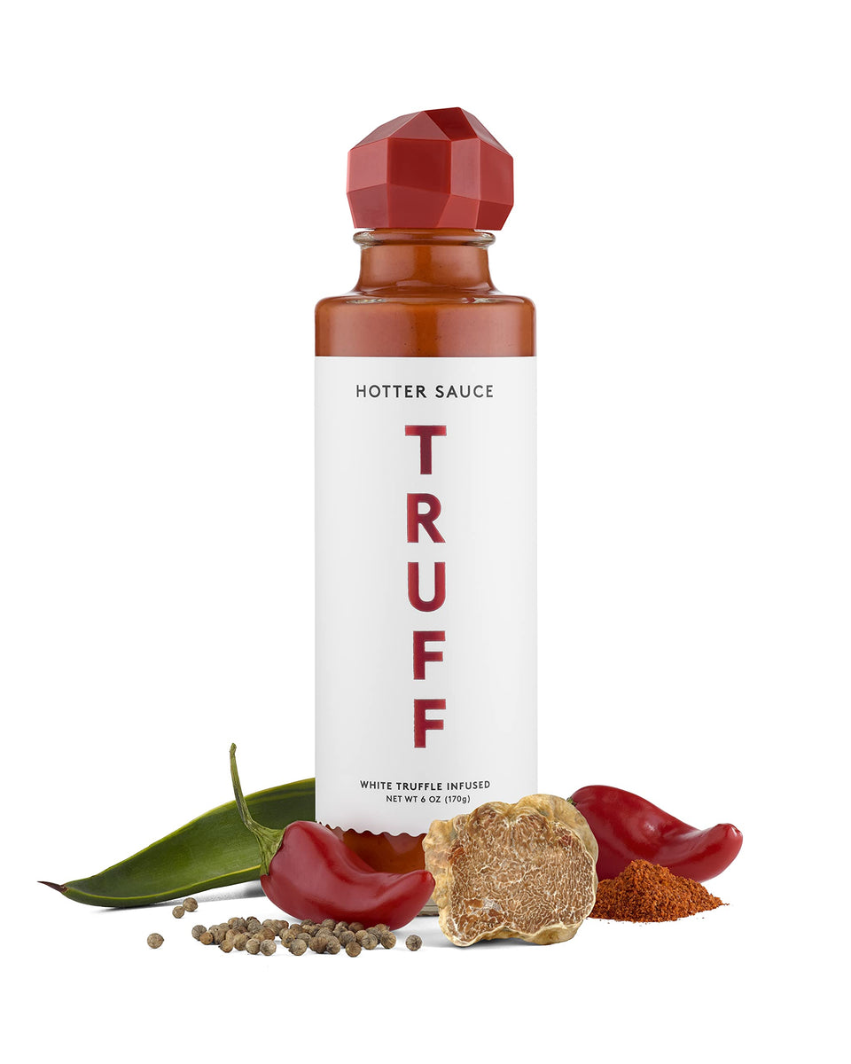 TRUFF White Hotter bottle pouring, adds bold heat to gourmet dishes.
