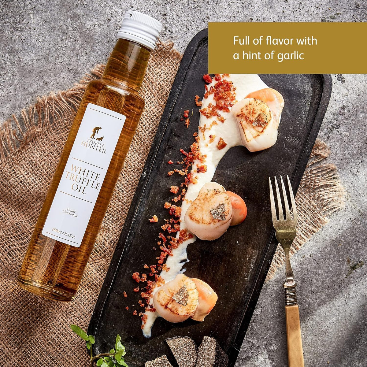 TruffleHunter white truffle oil drizzle drops finishing a dish.