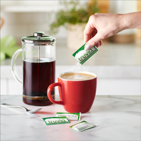 Truvia carton 140-count on kitchen counter for convenient sweetness.
