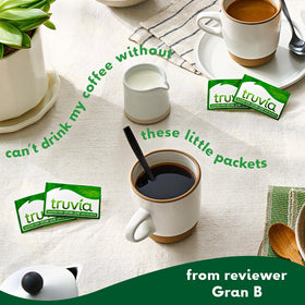 Truvia packets beside a coffee cup for calorie-free sugar alternative.