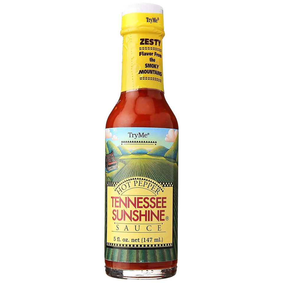Try Me Tennessee Sunshine hot pepper sauce bottle pour showing vibrant color for grilled dishes.