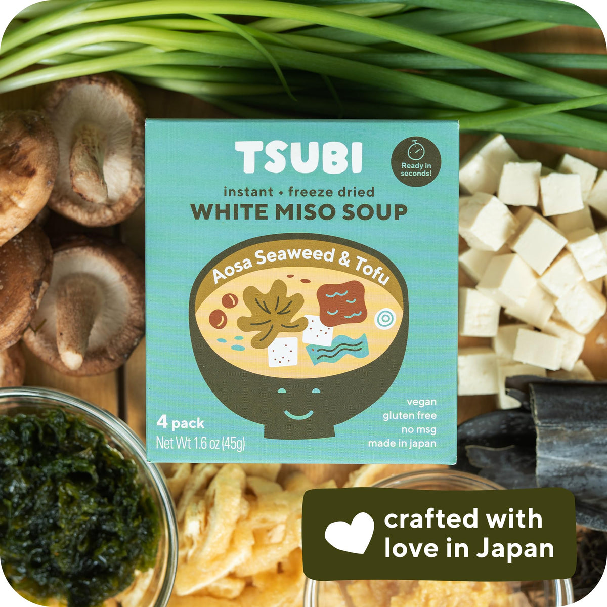 Close-up of miso cubes dissolving in broth.