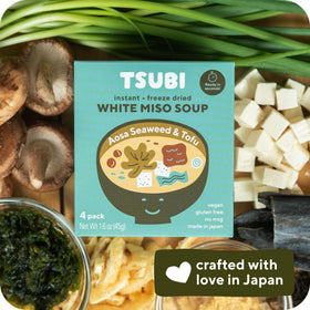 Close-up of miso cubes dissolving in broth.