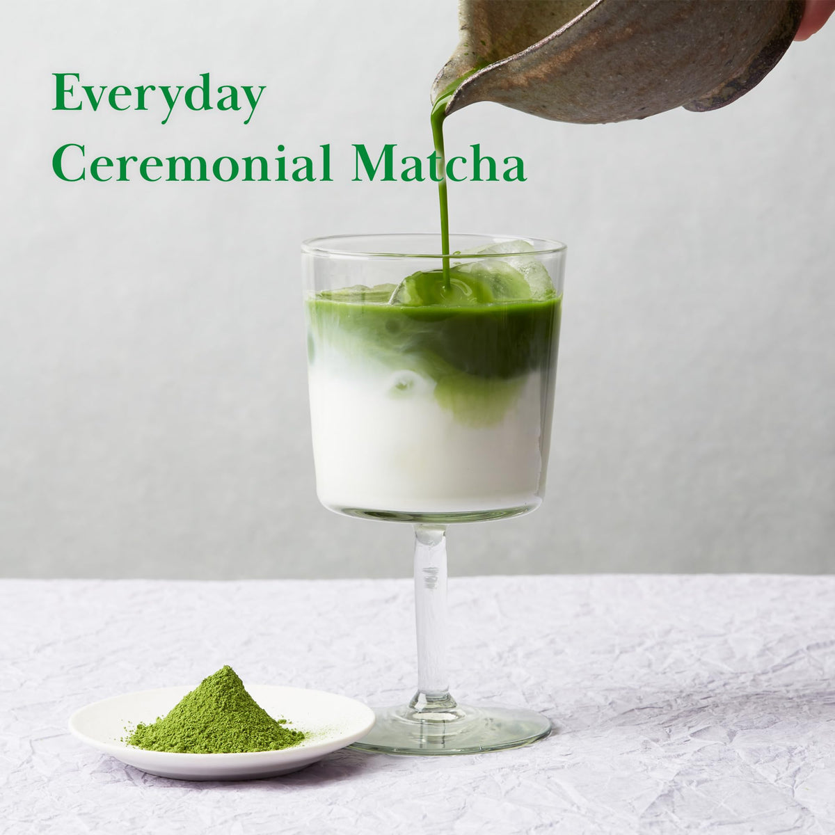 TSUJIRI Tsuji Midori bamboo whisk accompanying vibrant green tea powder.