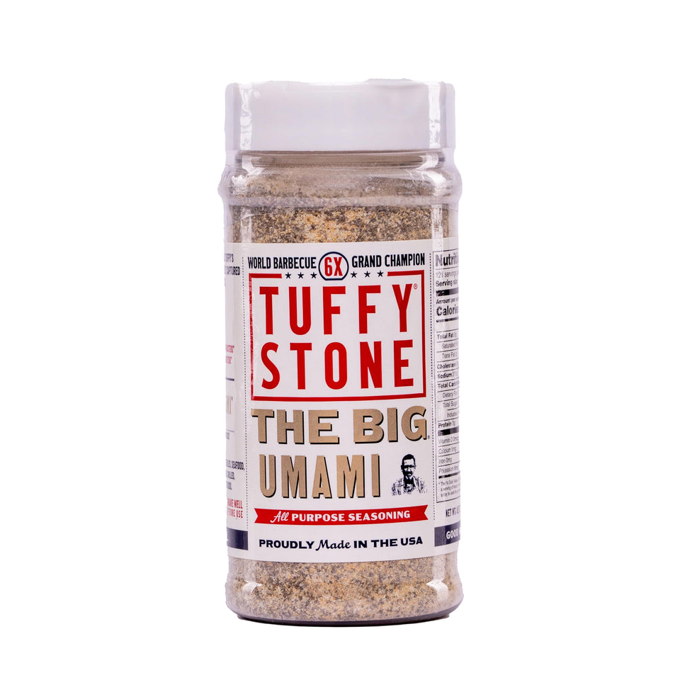 Tuffy Stone The Big Umami seasoning bottle pour enhances savory flavor on grilled foods.