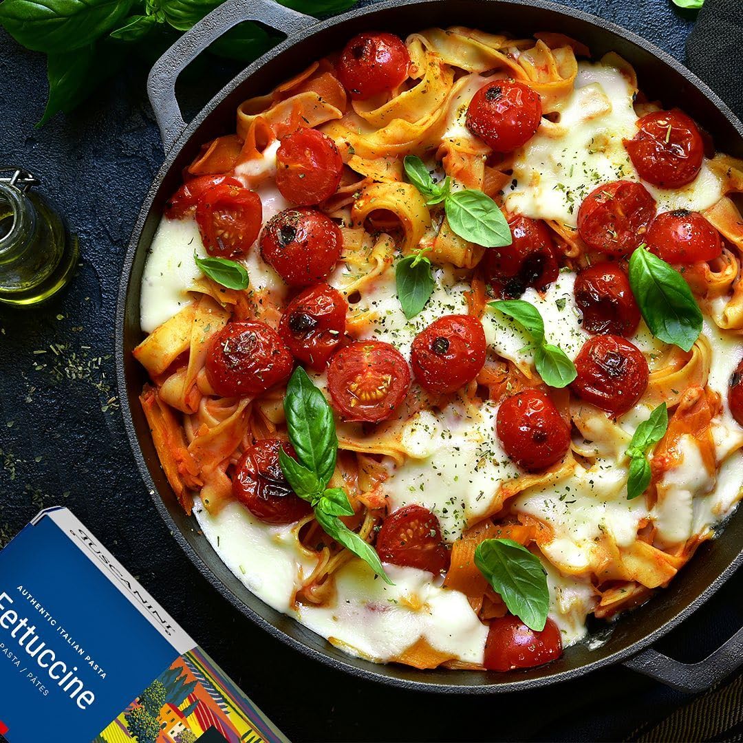 Cooked Tuscanini fettuccine plated with sauce and herbs