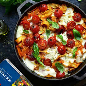 Cooked Tuscanini fettuccine plated with sauce and herbs
