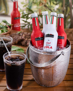 Tuscanini Organic Cola pour into a glass, signaling a refreshing dining moment.