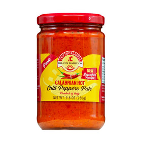 TUTTOCALABRIA chili paste pate jar on wood board, rich flavor ready for spreads.