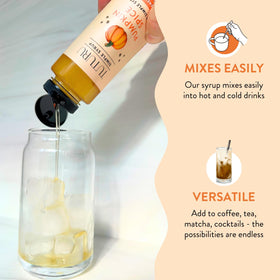 Tuturu Pumpkin Spice Agave Syrup bottle beside hot tea and pumpkin aroma