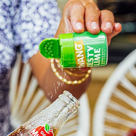 Twang Lime Snack Salt being poured onto a snack