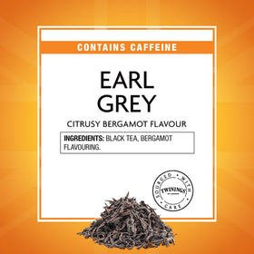 Twinings Earl Grey tea being poured into a cup with a lemon slice