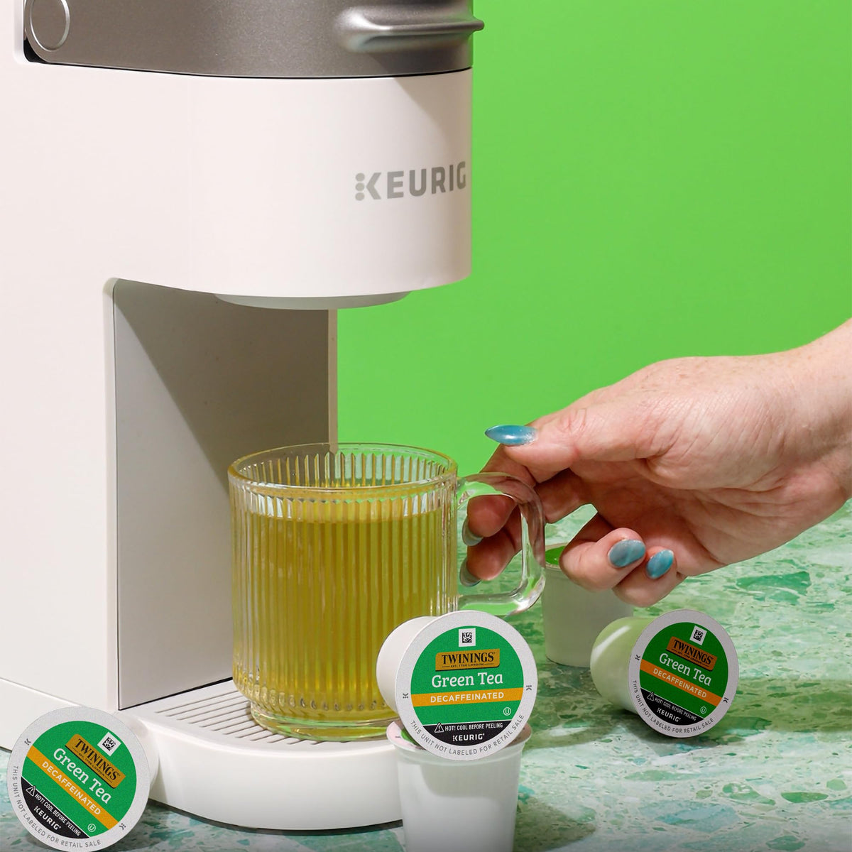 Twinings decaf green tea K-Cup aroma image emphasizes ethical sourcing and natural notes.