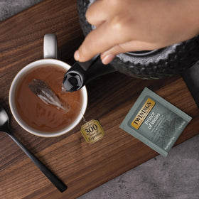 Hot cup of Twinings Prince of Wales with milk suggesting a creamy pairing