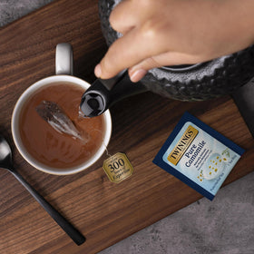 Twinings Pure Camomile tea box on shelf signals premium quality.