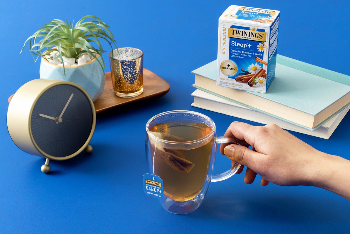 Twinings Sleep+ tea bag in cup releasing chamomile aroma for relaxation.