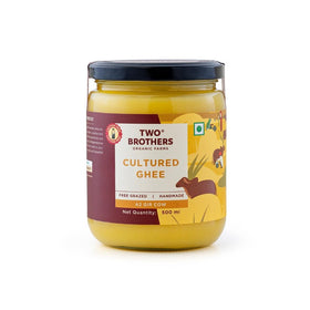Two Brothers India Farms A2 ghee bottle being poured, rich flavor for cooking