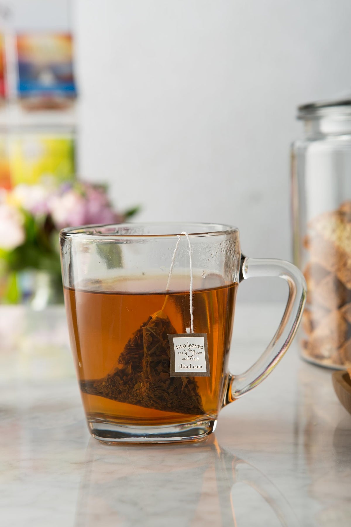 Hot tea being poured over bergamot-infused sachet, Two Leaves and a Bud.